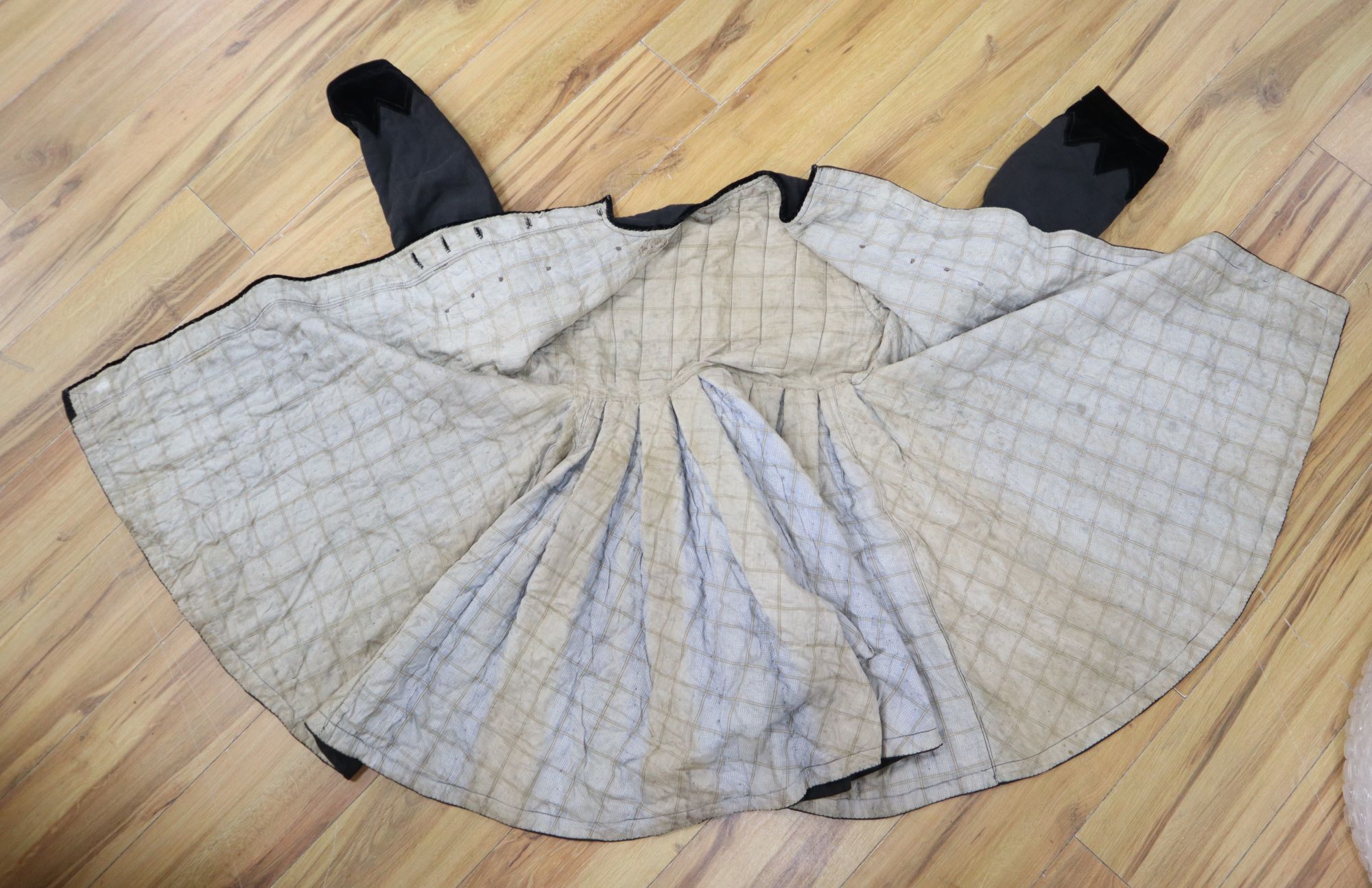A 19th century Russian linen velvet edged coat with padded lining